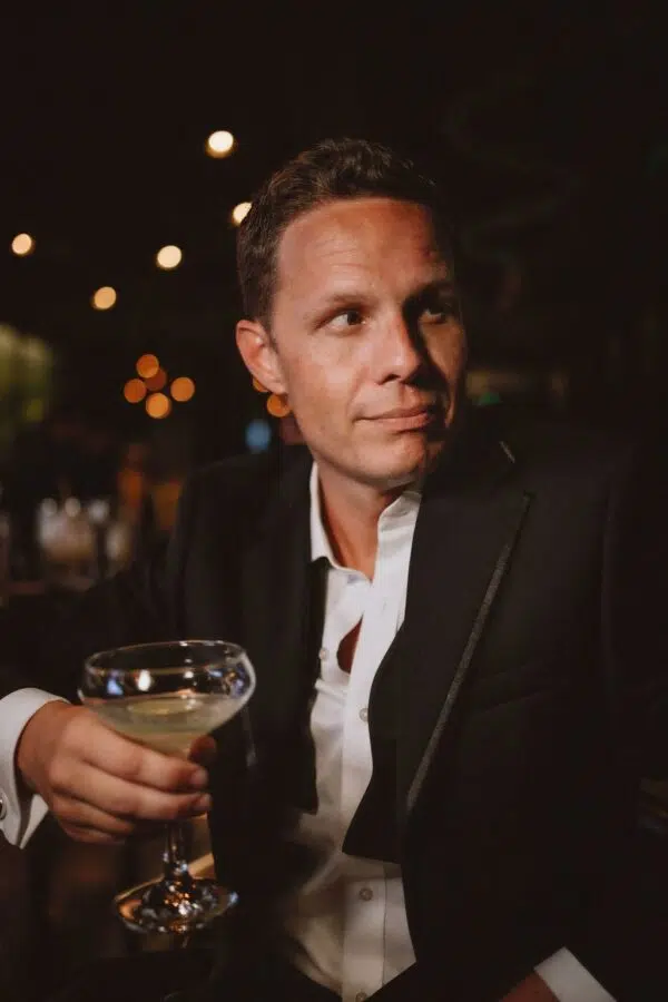 handsome man in a suit sipping a martini