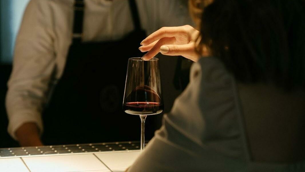 a woman stroking a glass of wine